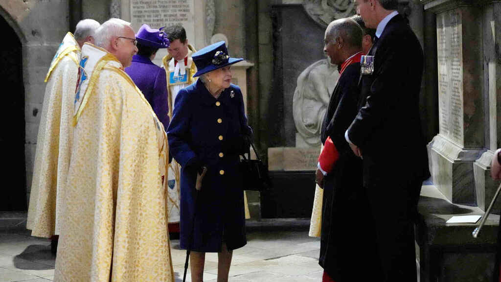 Queen Elizabeth II of England uses a walking cane at Westminster Abbey.