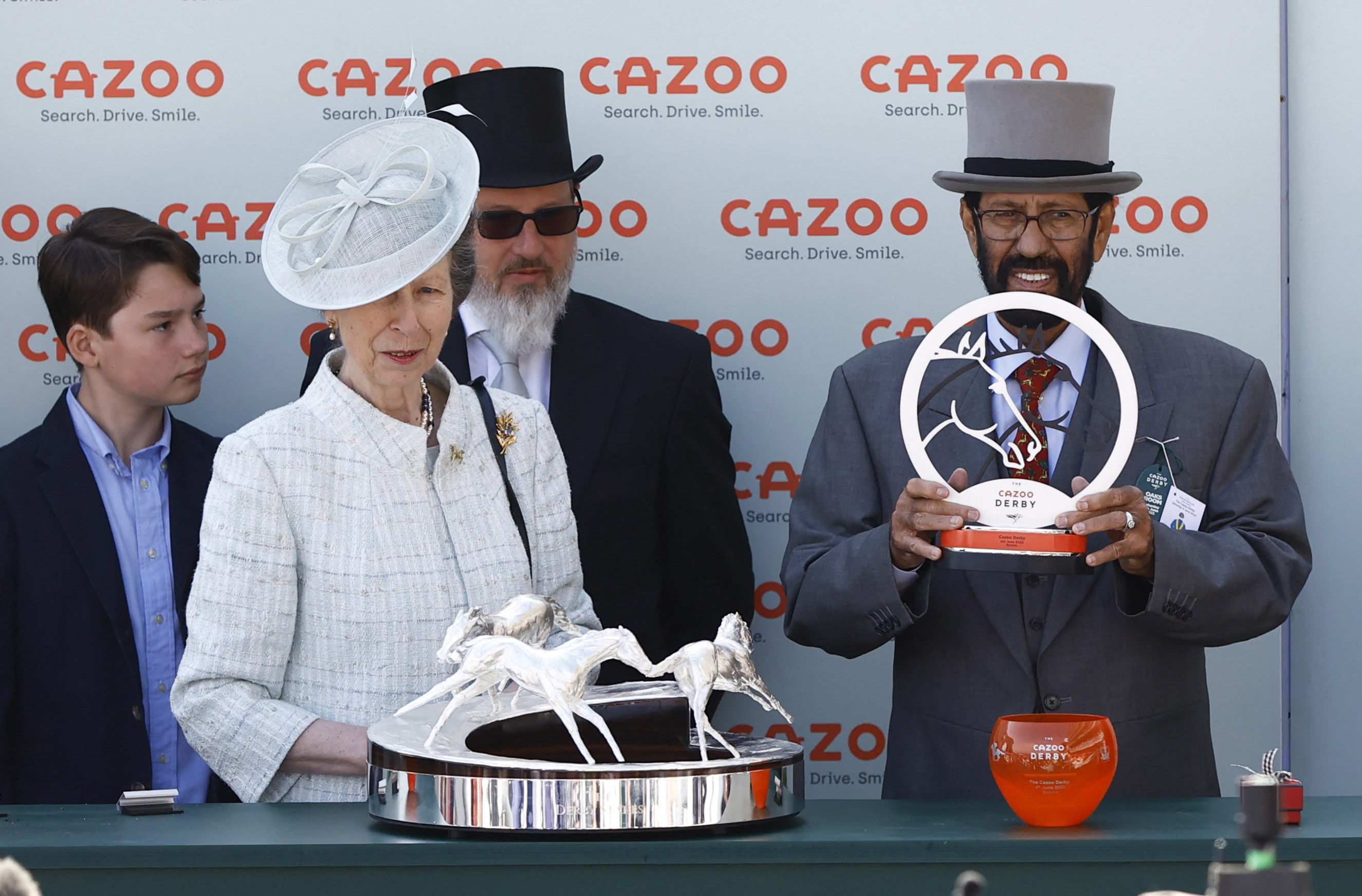 Desert Crown owner Saeed Sohail poses with the trophy with British Princess Anne after her victory in the Kazuo Derby at 16.30.