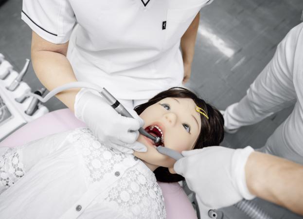 A Japanese human-like robot that mimics the reactions of a five-year-old boy at the dentist.