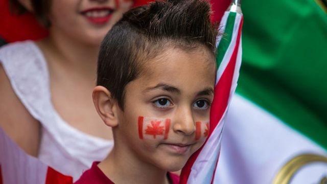 A boy has Canada's flag drawn across his cheeks during the Canada Day parade in Montreal, Quebec.