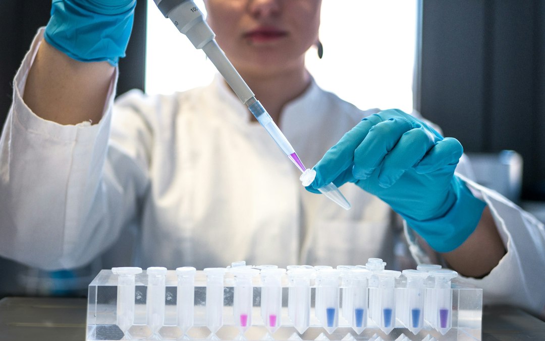 Pharmaceutical researcher working in a laboratory, representing drug development activity